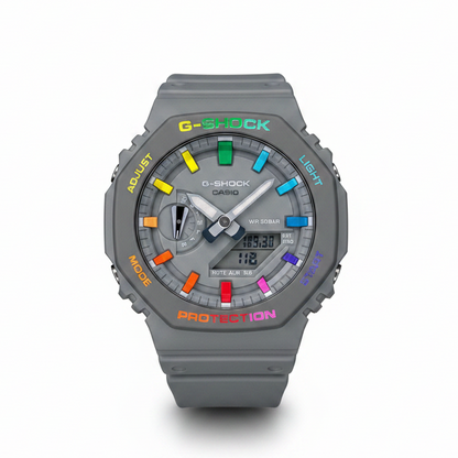 A hand-painted Casio G-Shock watch with colorful hour markers and text on the bezel, predominantly grey with rainbow-colored details.